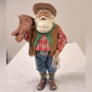 Vintage, Cowboy Jolly Santa holding a Saddle w/1 hand & a Rope on the other hand